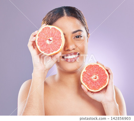 Woman, beauty and grapefruit for skincare, organic and natural on studio background. Fruit, citrus and vitamin c for moisturiser and cosmetic routine for self care, smile or portrait for female model Woman, beauty and grapefruit for skincare, organic and natural on studio background. Fruit, citrus and vitamin c for moisturiser and cosmetic routine for self care, smile or portrait for female model 142856903