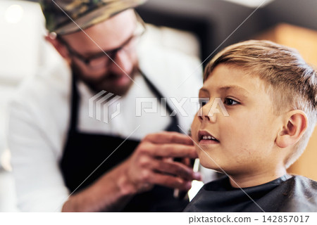 Child client, trim and barber in barbershop with clippers for cutting, makeover or grooming service. Boutique, customer and hairstylist for haircut, hair care or hairdresser treatment in salon Child client, trim and barber in barbershop with clippers for cutting, makeover or grooming service. Boutique, customer and hairstylist for haircut, hair care or hairdresser treatment in salon 142857017