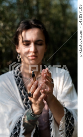 Glowing Palo Santo Stick with Smoke in Woman s Hands During Spiritual Cleansing Practice Glowing Palo Santo Stick with Smoke in Woman s Hands During Spiritual Cleansing Practice 142857109