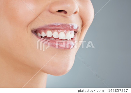 Dental, smile and mouth of woman in studio for teeth whitening, oral hygiene and satisfaction. Happy, female person and pride with wellness for cleaning, gum health and self care on grey background 142857217