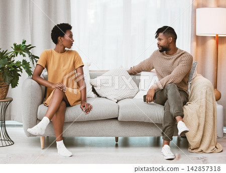 Couple, fight and talking about divorce of marriage on couch with conflict, challenge or communication. Angry, people or problem in relationship and sorry for cheating, affair or conversation in home Couple, fight and talking about divorce of marriage on couch with conflict, challenge or communication. Angry, people or problem in relationship and sorry for cheating, affair or conversation in home 142857318