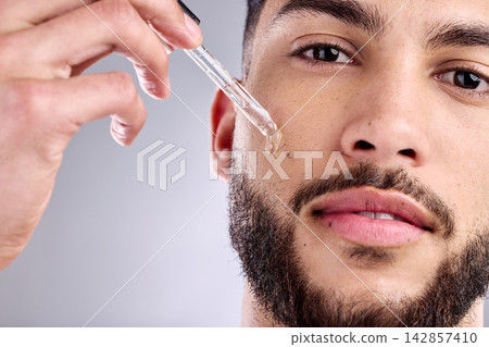 Beauty, portrait and serum with man in studio for antiaging dermatology, skincare or wellness. Aesthetic, face or natural oil and model with dropper to apply collagen or hyaluronic acid to skin Beauty, portrait and serum with man in studio for antiaging dermatology, skincare or wellness. Aesthetic, face or natural oil and model with dropper to apply collagen or hyaluronic acid to skin 142857410