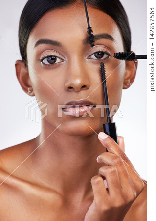 Studio, portrait and woman with mascara for makeup, beauty or cosmetics with confidence. Female model, hands and brush or product for eyelash, application or aesthetic with volume by white background Studio, portrait and woman with mascara for makeup, beauty or cosmetics with confidence. Female model, hands and brush or product for eyelash, application or aesthetic with volume by white background 142857563