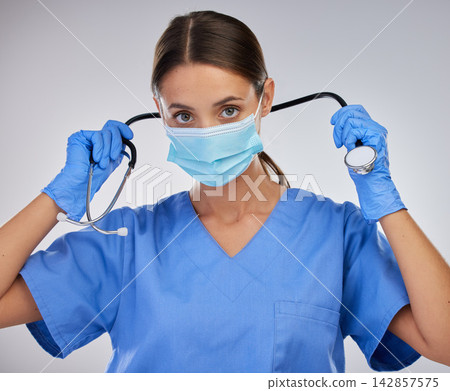 Mask, doctor and woman with stethoscope, studio and safety with gloves and PPE for healthcare. White background, medical and person with help, portrait and healthy in clinic and hands in hospital Mask, doctor and woman with stethoscope, studio and safety with gloves and PPE for healthcare. White background, medical and person with help, portrait and healthy in clinic and hands in hospital 142857575