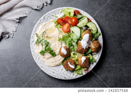 Falafel with hummus and fresh salad Falafel with hummus and fresh salad 142857588