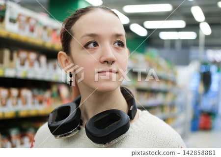 Confident teenage girl in supermarket symbolizes growing independence self identity everyday competence and readiness to make her own decisions 142858881