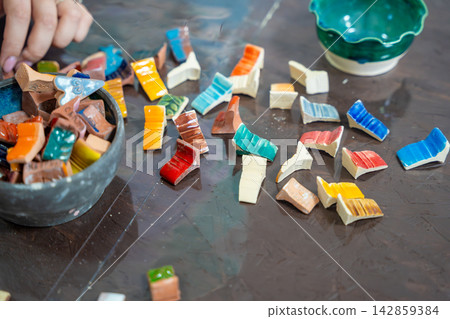 Colorful ceramic glaze test samples displayed in pottery workshop. Glaze test tiles help artists choose colors and finishes for handmade ceramics before decorating Colorful ceramic glaze test samples displayed in pottery workshop. Glaze test tiles help artists choose colors and finishes for handmade ceramics before decorating 142859384