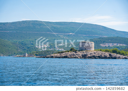 Historic Arza Fortress on the Lustica Peninsula in Montenegro on the Adriatic Sea. Military architecture overlooking the Bay of Kotor and protecting the coastal entrance. Historic Arza Fortress on the Lustica Peninsula in Montenegro on the Adriatic Sea. Military architecture overlooking the Bay of Kotor and protecting the coastal entrance. 142859682