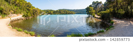 View of Malo Jezero or Small Lake in Mljet National Park on Mljet Island in Croatia. Protected Mediterranean nature and peaceful lake landscape concept. 142859773