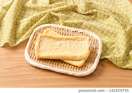 Deep-fried tofu placed on a sieve Deep-fried tofu placed on a sieve 142859795
