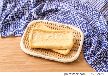Deep-fried tofu placed on a sieve Deep-fried tofu placed on a sieve 142859796