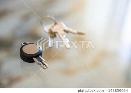 Traditional metal keys next to an RFID key fob on a white background. Concept of transition from mechanical locks to electronic access control and smart security. Traditional metal keys next to an RFID key fob on a white background. Concept of transition from mechanical locks to electronic access control and smart security. 142859934