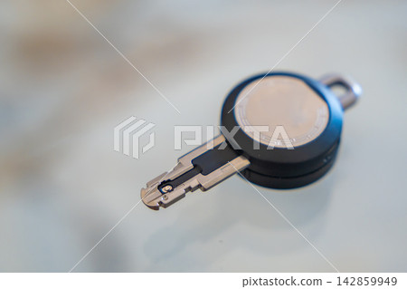 Close up of an RFID key fob with a visible electronic contact chip on a white background. Concept of electronic authentication, secure access and digital identification technology. Close up of an RFID key fob with a visible electronic contact chip on a white background. Concept of electronic authentication, secure access and digital identification technology. 142859949