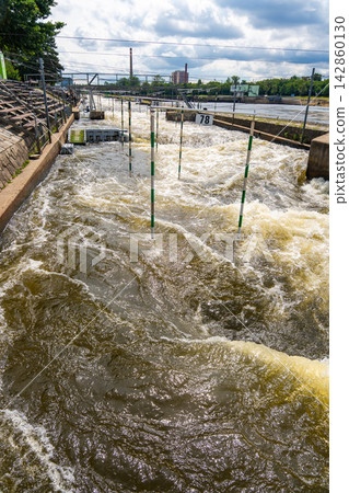 Artificial whitewater slalom course with numbered gates on the Vltava River in Prague Czech Republic. Outdoor kayaking training and canoe slalom concept for water sports and active recreation. 142860130