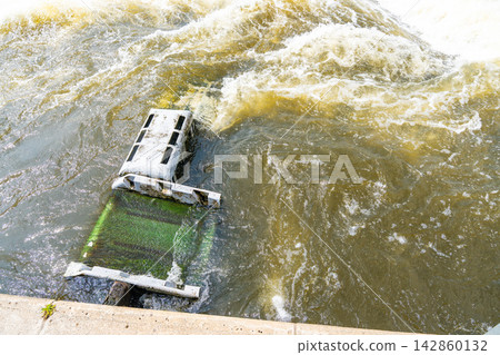 Artificial whitewater obstacle creating rapids inside a slalom course on the Vltava River in Prague Czech Republic. Whitewater engineering and controlled water flow for kayaking and canoe training. Artificial whitewater obstacle creating rapids inside a slalom course on the Vltava River in Prague Czech Republic. Whitewater engineering and controlled water flow for kayaking and canoe training. 142860132