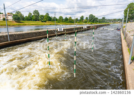 Artificial whitewater slalom course with numbered gates on the Vltava River in Prague Czech Republic. Outdoor kayaking training and canoe slalom concept for water sports and active recreation. 142860136