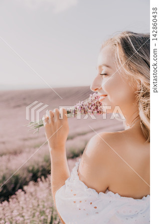Lavender woman flower smelling a fragrant bouquet in a sunlit purple field during a peaceful summer afternoon 142860438