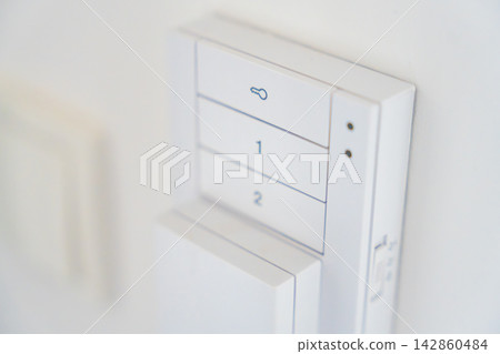 Close up of a home intercom control panel on a wall near an apartment entrance. Residential access control concept for security, communication and visitor management. Close up of a home intercom control panel on a wall near an apartment entrance. Residential access control concept for security, communication and visitor management. 142860484