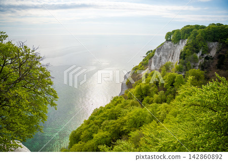 View of famous white chalk cliffs and Baltic Sea from suspension bridge in Jasmund National Park on Ruegen island, Germany View of famous white chalk cliffs and Baltic Sea from suspension bridge in Jasmund National Park on Ruegen island, Germany 142860892