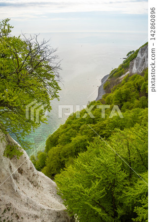 View of famous white chalk cliffs and Baltic Sea from suspension bridge in Jasmund National Park on Ruegen island, Germany View of famous white chalk cliffs and Baltic Sea from suspension bridge in Jasmund National Park on Ruegen island, Germany 142860896