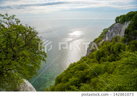 View of famous white chalk cliffs and Baltic Sea from suspension bridge in Jasmund National Park on Ruegen island, Germany View of famous white chalk cliffs and Baltic Sea from suspension bridge in Jasmund National Park on Ruegen island, Germany 142861073