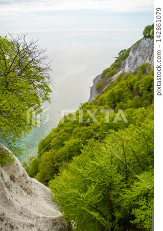 View of famous white chalk cliffs and Baltic Sea from suspension bridge in Jasmund National Park on Ruegen island, Germany View of famous white chalk cliffs and Baltic Sea from suspension bridge in Jasmund National Park on Ruegen island, Germany 142861079