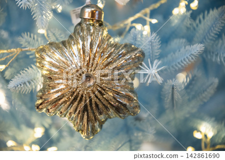Golden Christmas ornament on white fir branch Golden Christmas ornament on white fir branch 142861690