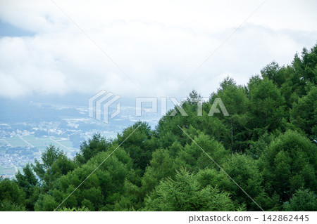 A town nestled in the mountains, shrouded in mist A town nestled in the mountains, shrouded in mist 142862445