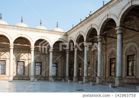 Beautiful rectangular sahn surrounded by riwaqs supported by columns and covered by domes. Mosque of Muhammad Ali or Alabaster Mosque, Cairo, Egypt Beautiful rectangular sahn surrounded by riwaqs supported by columns and covered by domes. Mosque of Muhammad Ali or Alabaster Mosque, Cairo, Egypt 142863758