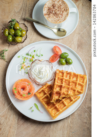 Crunchy waffle fries with sour cream dip served in a basket Crunchy waffle fries with sour cream dip served in a basket 142863784