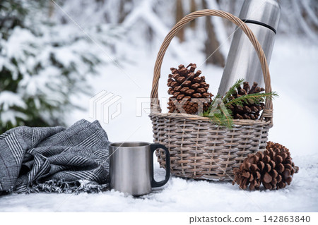 Hot drink in stainless steel cup outdoors in winter Hot drink in stainless steel cup outdoors in winter 142863840