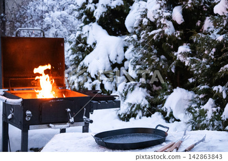 Winter outdoor cooking on grill Winter outdoor cooking on grill 142863843