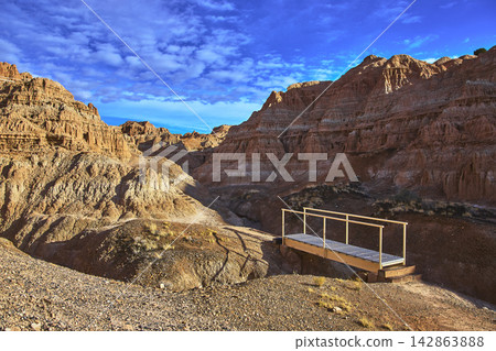 Cathedral Gorge State Park Bridge and Rugged Cliffs Under Blue Sky Nevada Cathedral Gorge State Park Bridge and Rugged Cliffs Under Blue Sky Nevada 142863888