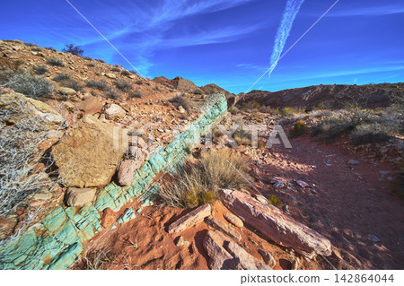 Green Mineral Vein and Red Rock Formations in Nevada Desert Landscape 142864044