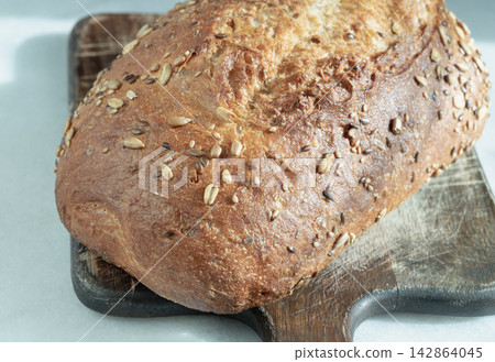 Seeded Sourdough loaf, characterized by its use of organic ingredients and a mix of various seeds, including pumpkin, sunflower, sesame and linseed. Seeded Sourdough loaf, characterized by its use of organic ingredients and a mix of various seeds, including pumpkin, sunflower, sesame and linseed. 142864045