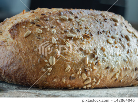 Seeded Sourdough loaf, characterized by its use of organic ingredients and a mix of various seeds, including pumpkin, sunflower, sesame and linseed. Seeded Sourdough loaf, characterized by its use of organic ingredients and a mix of various seeds, including pumpkin, sunflower, sesame and linseed. 142864046
