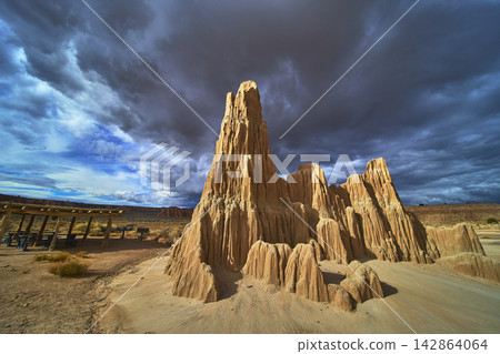 Cathedral Gorge Dramatic Rock Formations and Desert Landscape Under Storm Clouds Cathedral Gorge Dramatic Rock Formations and Desert Landscape Under Storm Clouds 142864064