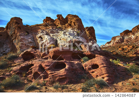 Red Sandstone Formations and Desert Landscape with Blue Sky in Bowl of Fire Nevada Red Sandstone Formations and Desert Landscape with Blue Sky in Bowl of Fire Nevada 142864087