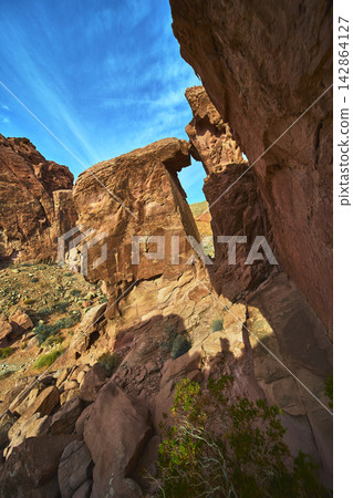 Sandstone Arch and Rugged Red Rock Formations Under Blue Sky in Bowl of Fire Nevada Sandstone Arch and Rugged Red Rock Formations Under Blue Sky in Bowl of Fire Nevada 142864127