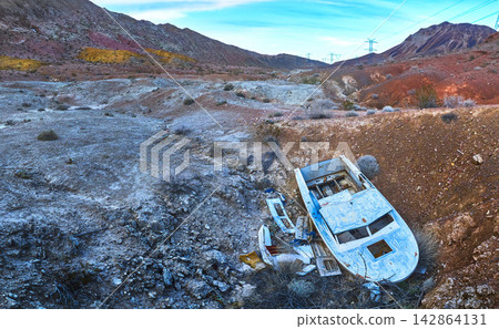 Aerial Abandoned Boat in Nevada Desert with Lava Butte and Rugged Landscape Aerial Abandoned Boat in Nevada Desert with Lava Butte and Rugged Landscape 142864131