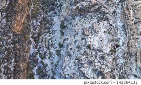 Aerial Rugged Canyon Walls Dry Wash and Cave Entrance in Nevada Desert Aerial Rugged Canyon Walls Dry Wash and Cave Entrance in Nevada Desert 142864132