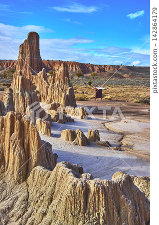 Cathedral Gorge State Park Clay Formations and Desert Landscape Under Blue Sky Cathedral Gorge State Park Clay Formations and Desert Landscape Under Blue Sky 142864179