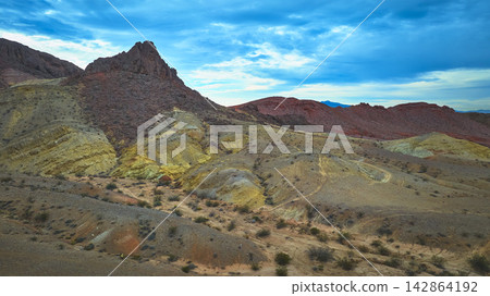 Aerial Dramatic Desert Landscape Rugged Hills and Colorful Volcanic Formations Aerial Dramatic Desert Landscape Rugged Hills and Colorful Volcanic Formations 142864192