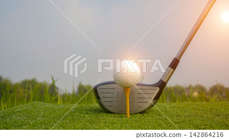 Golf club and ball in green grass. 142864216