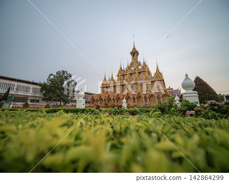 The Golden Castle at Wat ThaSung, Uthai Thani, glows at sunset on September 17, 2017 or 2560 BE. The Golden Castle at Wat ThaSung, Uthai Thani, glows at sunset on September 17, 2017 or 2560 BE. 142864299