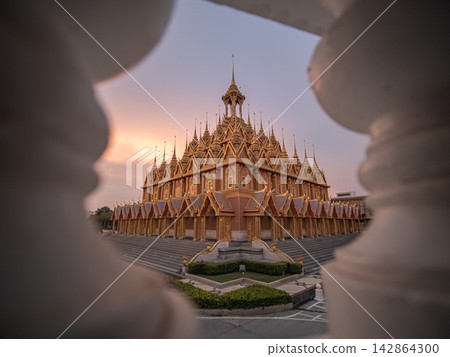 The Golden Castle at Wat ThaSung, Uthai Thani, glows at sunset on September 17, 2017 or 2560 BE. The Golden Castle at Wat ThaSung, Uthai Thani, glows at sunset on September 17, 2017 or 2560 BE. 142864300