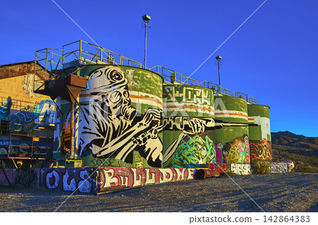 Abandoned Goldome Mill Graffiti Art Storage Tanks at Golden Hour in Mojave Desert Abandoned Goldome Mill Graffiti Art Storage Tanks at Golden Hour in Mojave Desert 142864383
