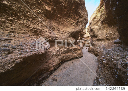 Slot Canyon Path Rugged Sandstone Walls and Sunlit Desert Adventure Slot Canyon Path Rugged Sandstone Walls and Sunlit Desert Adventure 142864589