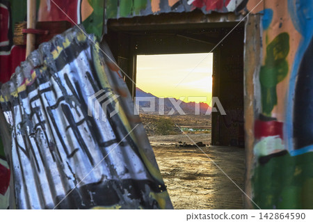 Graffiti Covered Abandoned Doorway Opens to Mojave Desert Sunset California Graffiti Covered Abandoned Doorway Opens to Mojave Desert Sunset California 142864590