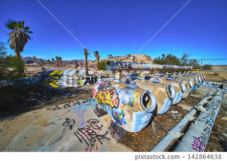Abandoned Graffiti Covered Water Park Pipes and Palm Trees in California Desert Abandoned Graffiti Covered Water Park Pipes and Palm Trees in California Desert 142864638